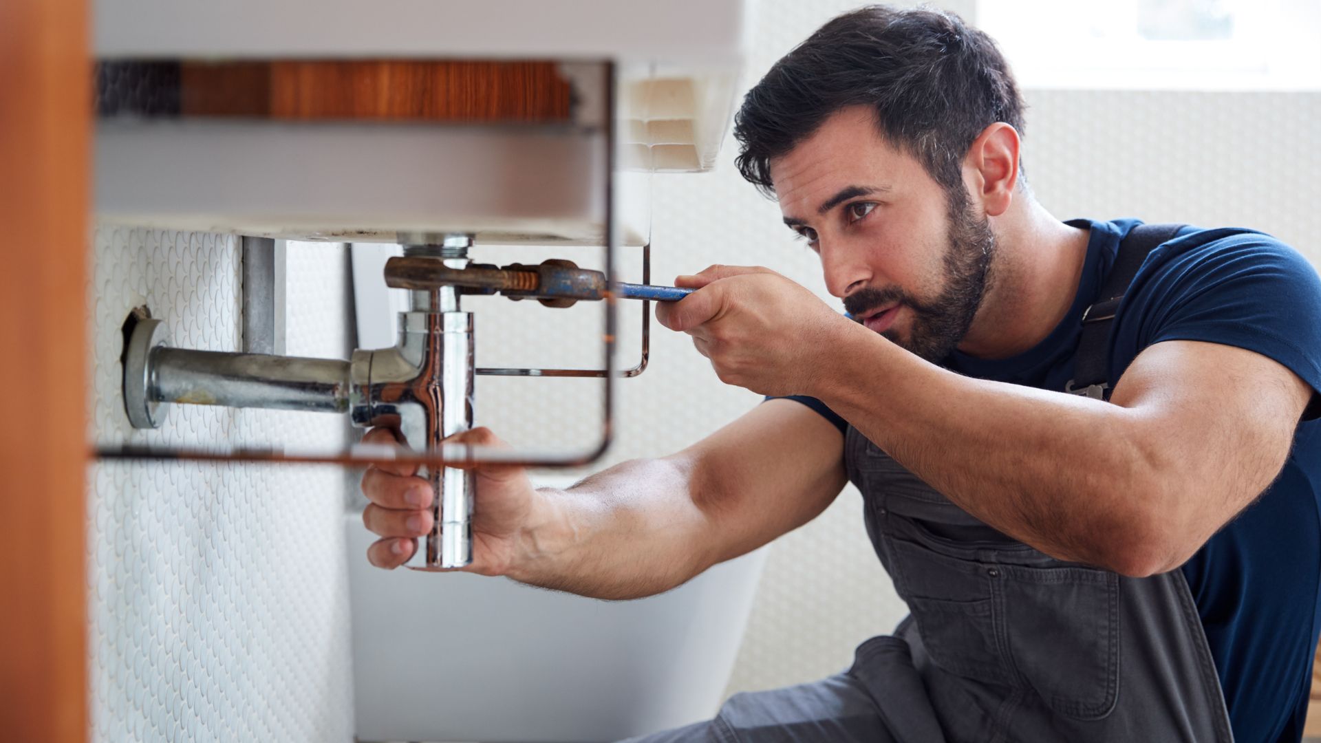 A plumber doing a leak repair