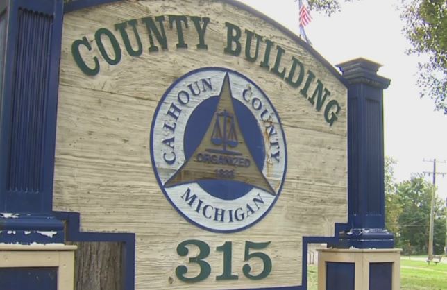 Sign of calhoun county building in michigan, displaying the county's seal and address number 315.