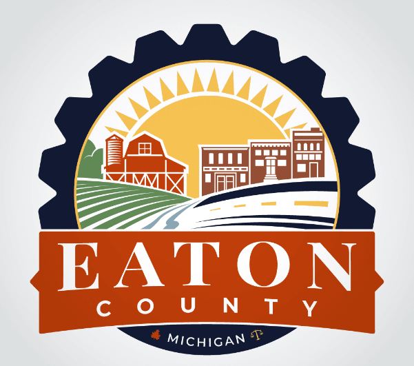 Logo of eaton county, michigan featuring rural and urban elements with a rising sun.