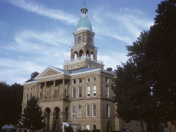 Historic courthouse building with a clock tower under a clear sky.