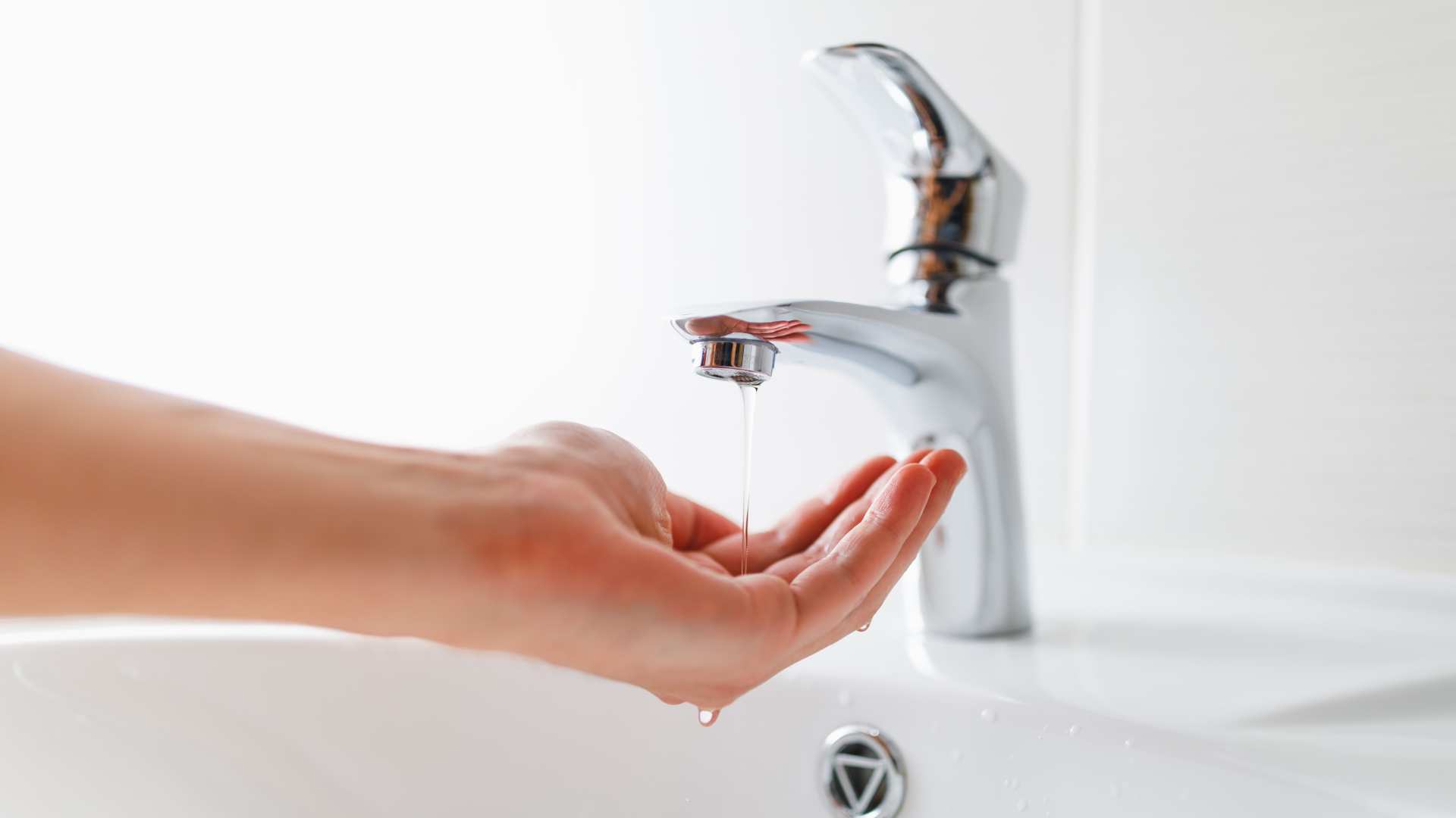 A hand under a running faucet