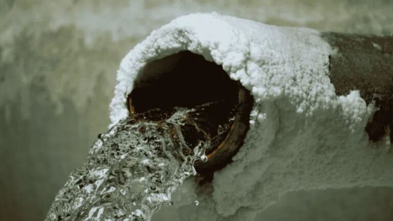 a close up of a frozen metal pipe
