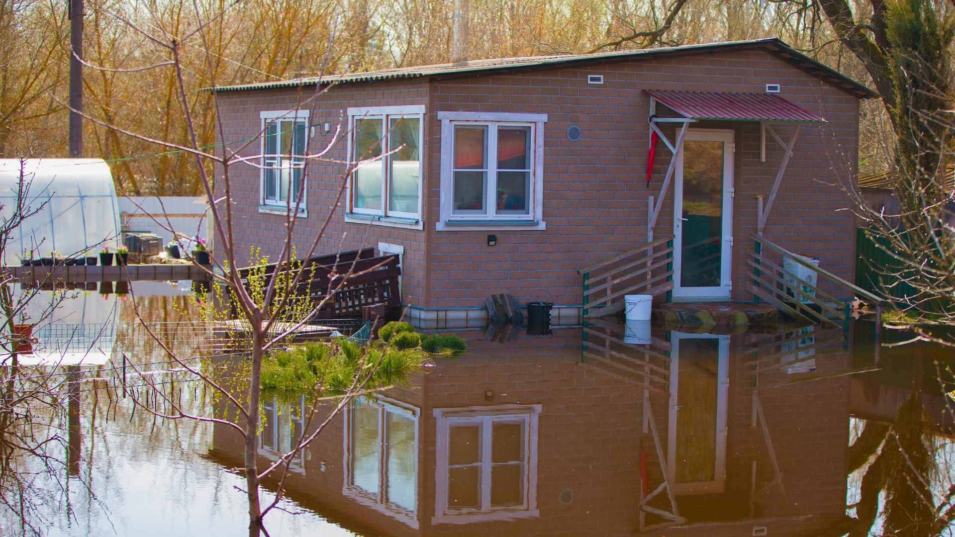 A small house surrounded by floodwater